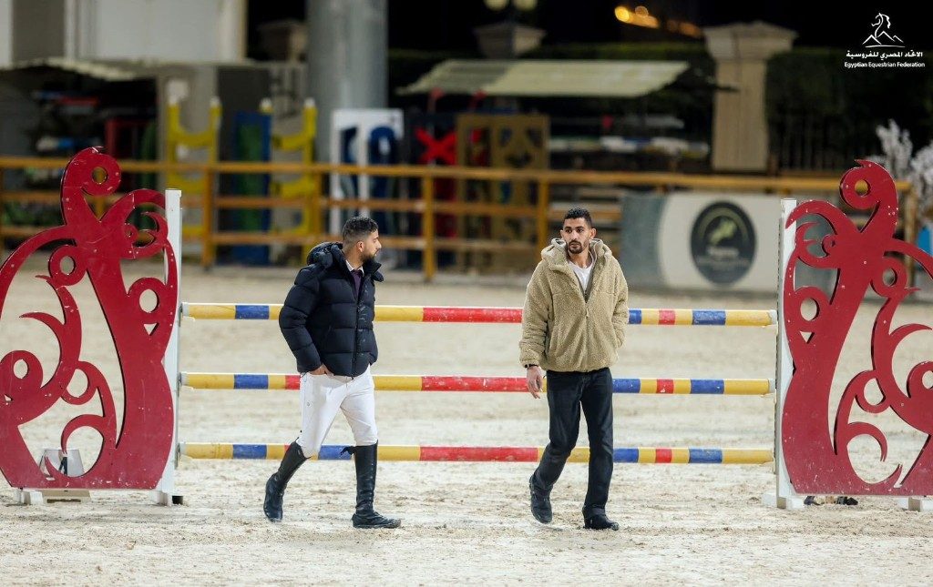 Riders at Equus arena with show jump